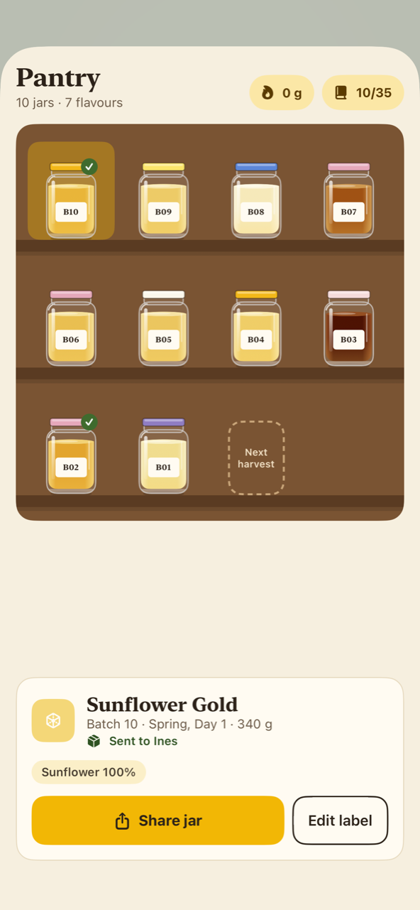 The pantry: ten jars on wooden shelves, from pale gold to nearly black, with a card for a jar of Sunflower Gold below