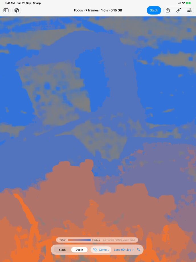 The depth map of the same stack: warm colour across the foreground heather, cool across the distant valley, and flat grey across the sky where nothing was in focus
