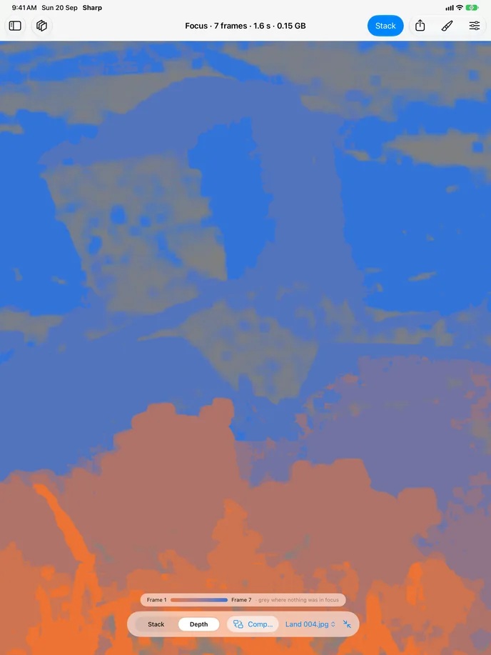 The depth map of the same stack: warm colour across the foreground heather, cool across the distant valley, and flat grey across the sky where nothing was in focus