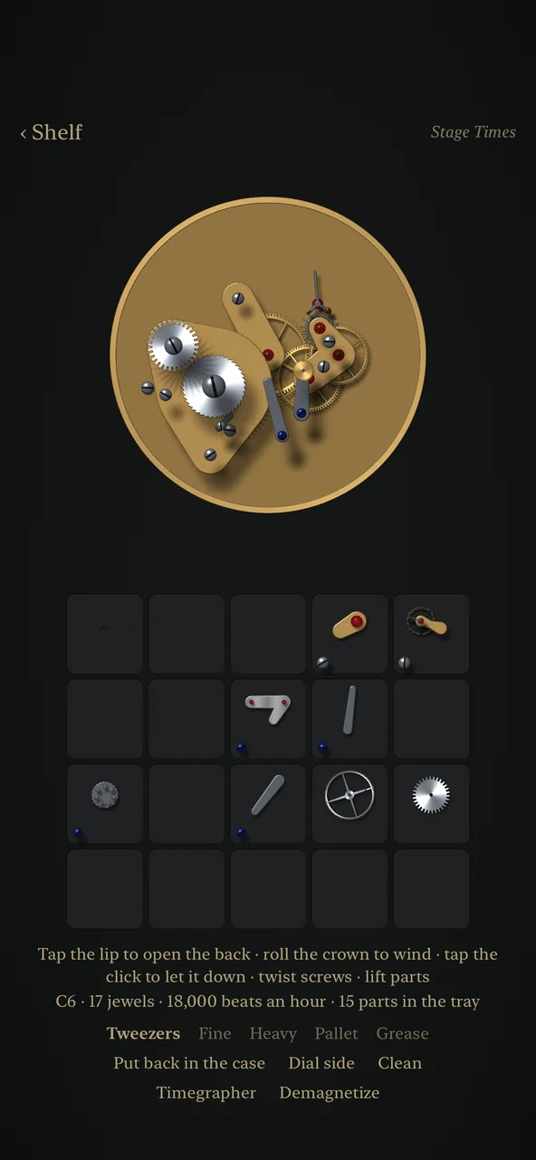 A chronograph movement half apart on the bench, its bridges lifted and lying in the numbered compartments of the parts tray below